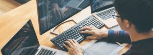 man at computer optimizing his tech stack